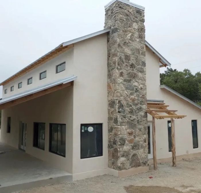 Stone chimney exterior with lime plaster walls