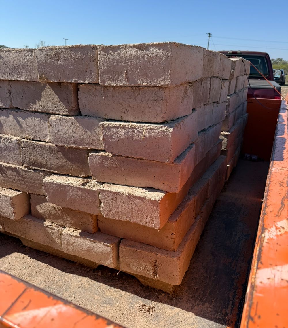 A pallet of finished adobe bricks loaded on a trailer