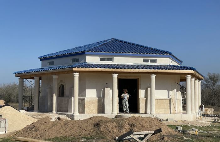 House exterior with blue clay tile roof under construction