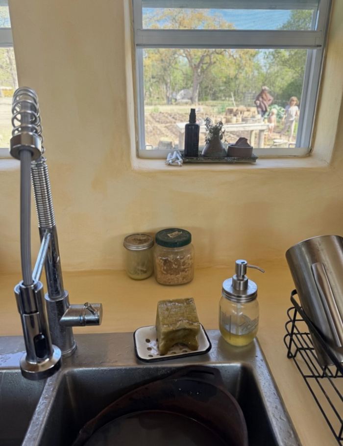 Golden lime plaster kitchen wall behind sink