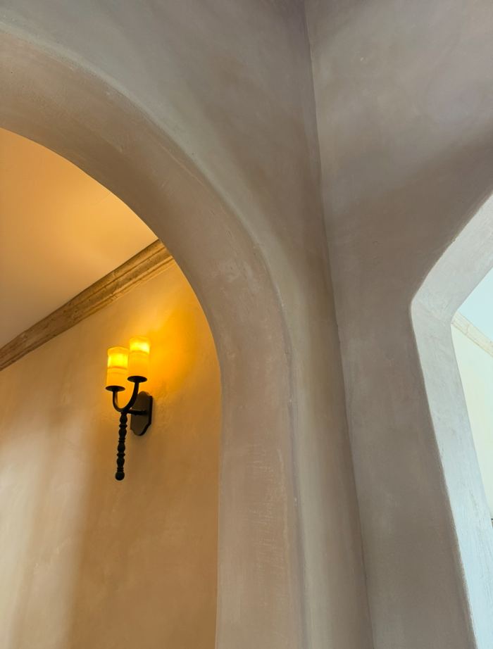 Lime plaster archway with wall sconce