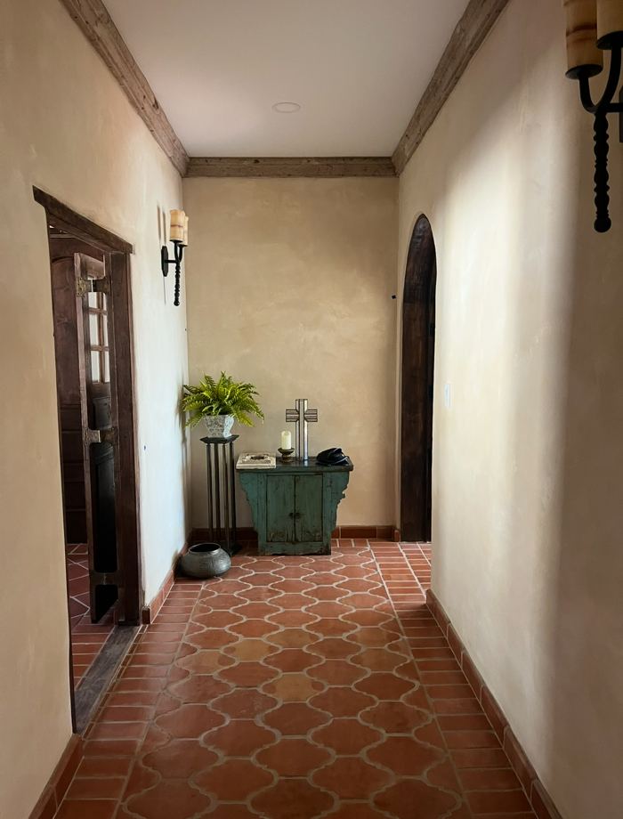 Terracotta tile hallway with lime plaster walls
