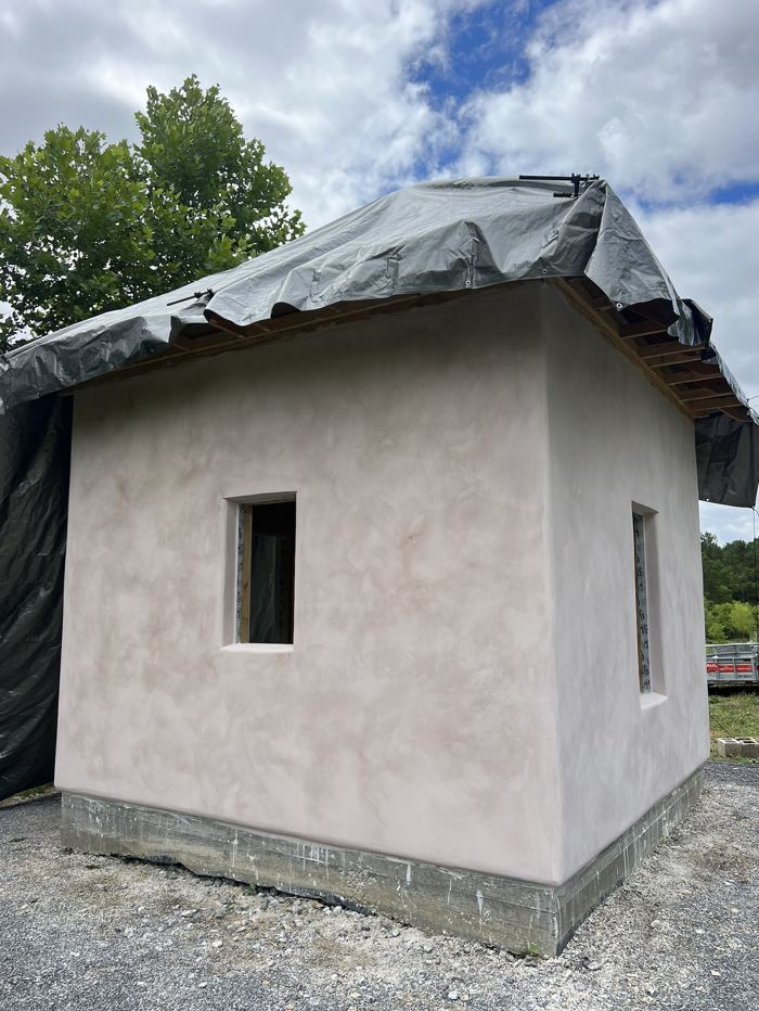 Pink lime plaster building under construction
