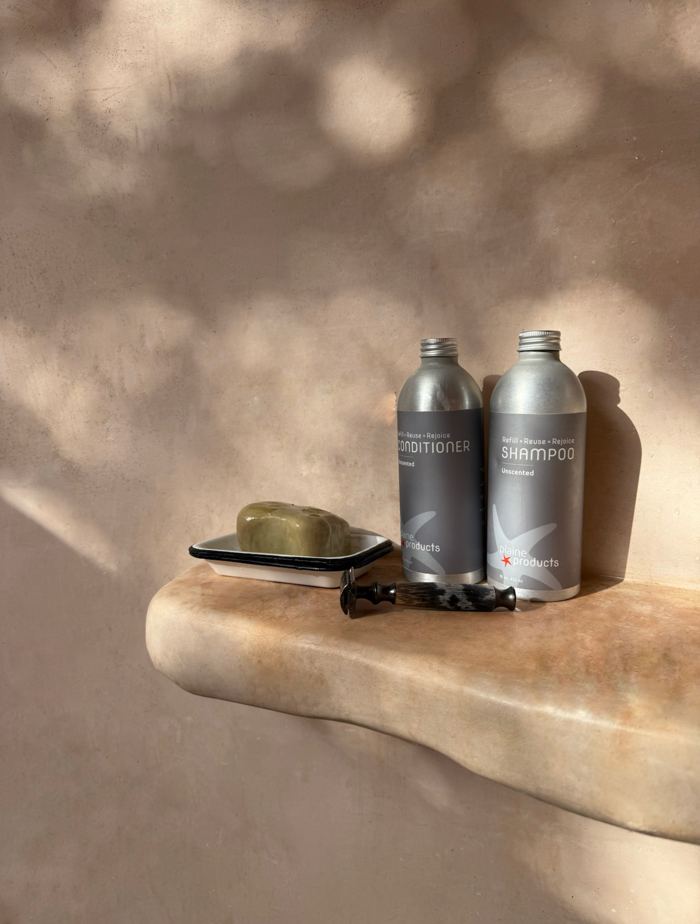 Tadelakt bath shelf with amenities in warm light