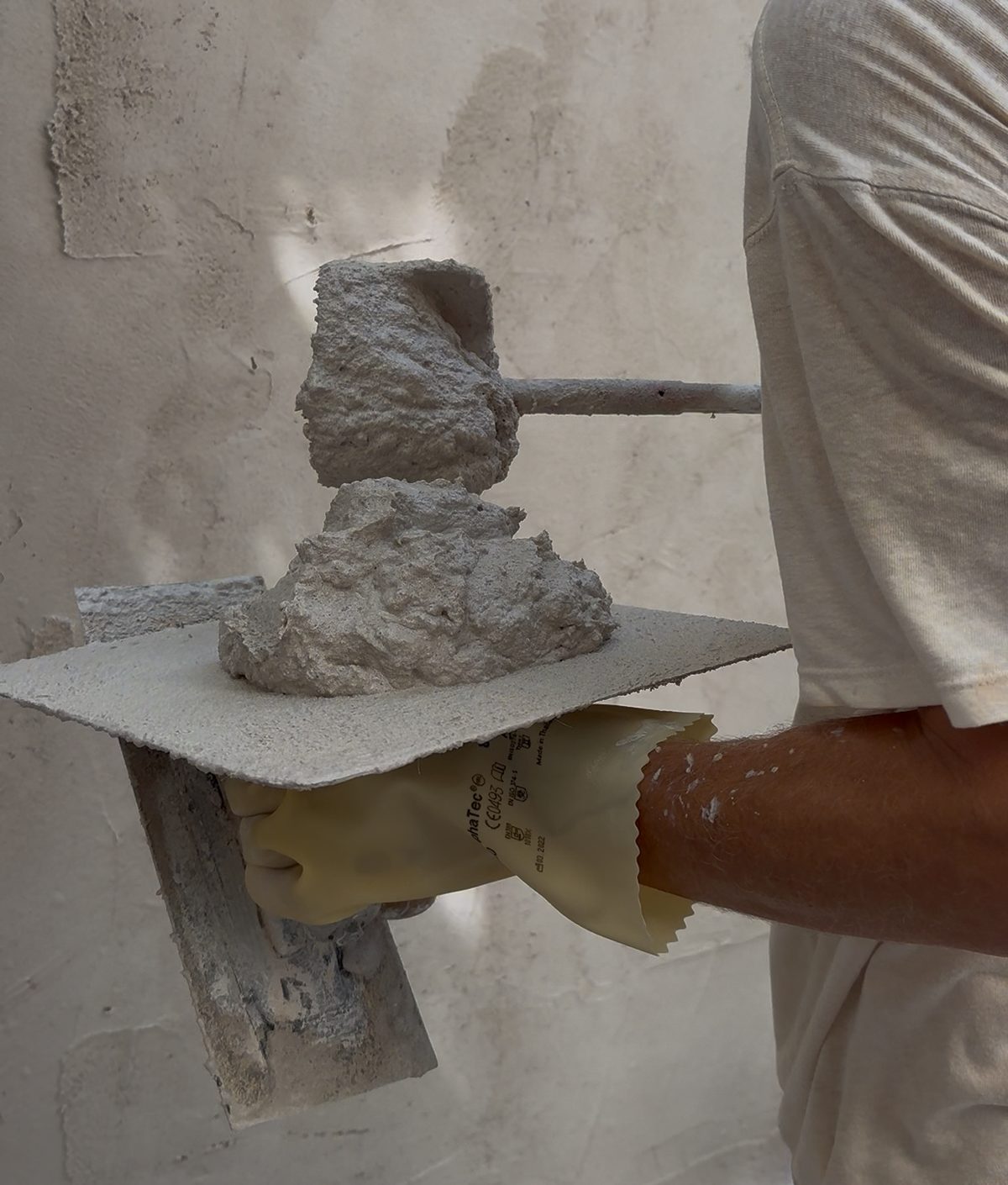 Freshly mixed lime plaster on a hawk and trowel