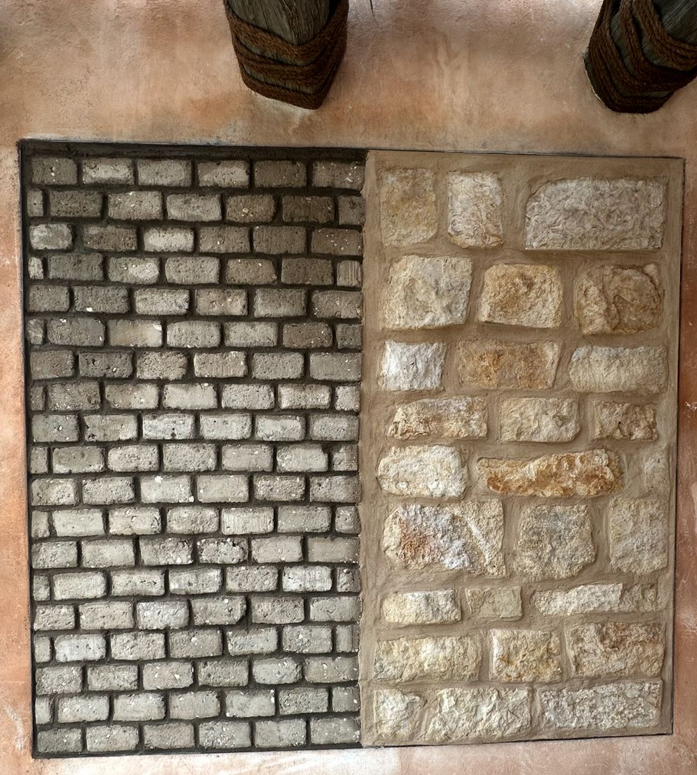 Side by side adobe brick and limestone wall sample panel set into a lime plastered wall